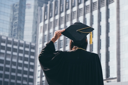 A Graduate Looks Towards Building in Cap and Gown